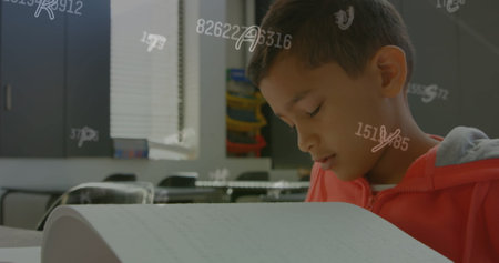 Image of letters and numbers over biracial schoolboy reading braille. Disability, school, learning and education concept digitally generated image.の写真素材