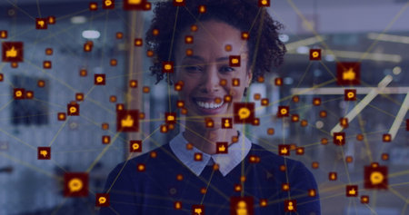 Image of network of digital icons against biracial woman smiling at office. Global networking and business technology conceptの写真素材