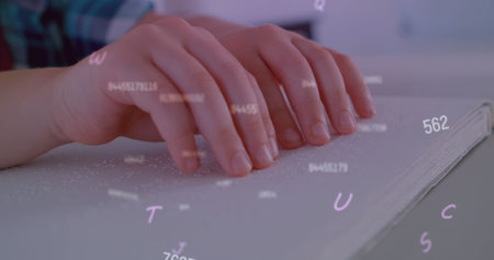 Image of letters and numbers over caucasian schoolchild reading braille. Disability, school, learning and education concept digitally generated image.の写真素材
