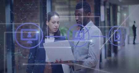 Image of lines, connected icons over connected dots, diverse coworkers discussing reports. Digital...
