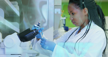 Image of medical interfaces over african american female scientist taking sample from test tube....