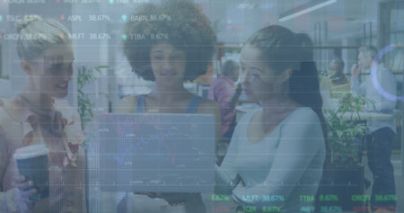 Image of graphs and trading board over diverse female colleague discussing over laptop. Digital...