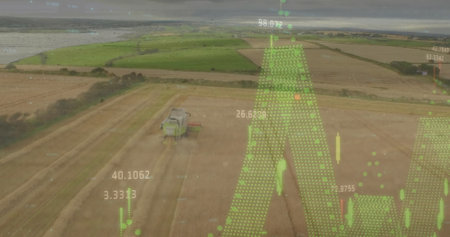 Image of graphs with numbers over aerial view of tractor in field against sky. Digital composite, multiple exposure, report, business, digit, drone and technology concept.の写真素材