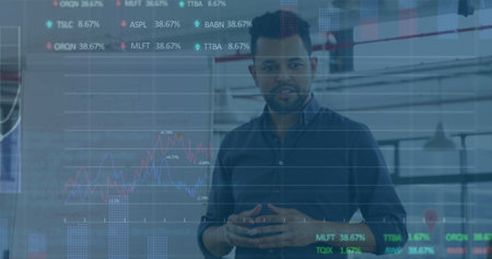 Image of stock market data processing over biracial man discussing with a colleague at office....