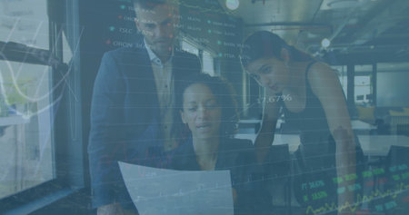 Image of data processing against diverse businesspeople discussing over document at office. Global economy and business data technology conceptの写真素材