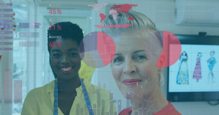 Image of statistical data processing over two diverse female fashion designers smiling at studio. Computer interface and business data technology conceptの写真素材
