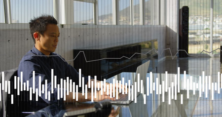 Image of financial data processing over asian businessman using laptop. Global computing, digital...
