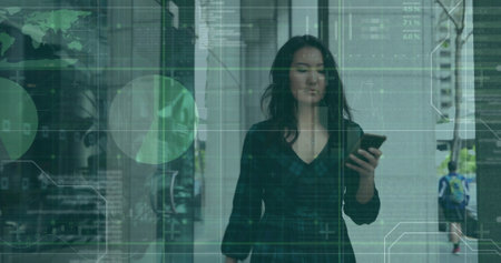 Image of infographic interface over asian woman scrolling on smartphone while walking in office. Digital composite, multiple exposure, report, business, global and technology concept.の写真素材