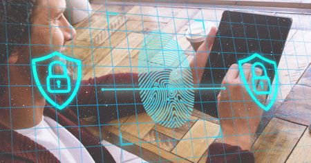 Image of fingerprint and padlock in shields over caucasian man scrolling on digital tablet. Digital...