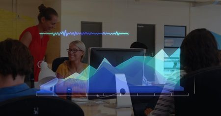 Image of graphs and soundwaves over caucasian colleagues using computer and giving high-five....