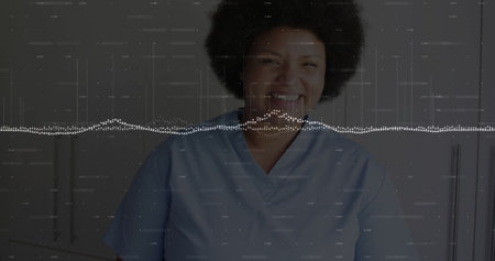 Image of data processing over smiling biracial female doctor. Global medicine, connections, computing and data processing concept digitally generated image.の写真素材