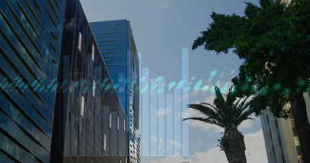 Image graphs, globe and changing numbers over low angle view of trees and modern buildings. Digital composite, multiple exposure, report, business, globalization and technology concept.の写真素材