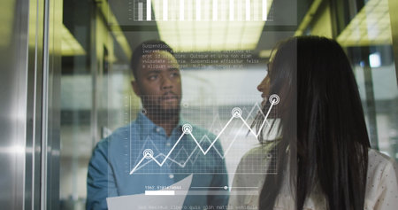 Image of graphs, loading bars over diverse coworkers discussing while walking in office corridor. Digital composite, multiple exposure, report, business, planning and teamwork concept.の写真素材