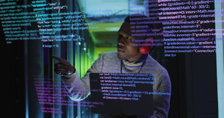 Image of data processing over african american male engineer with laptop working at server room. Computer interface and business data storage technology conceptの写真素材