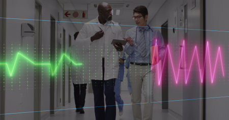 Image of heart rate monitor over two diverse male doctors discussing in hospital corridor. Medical...