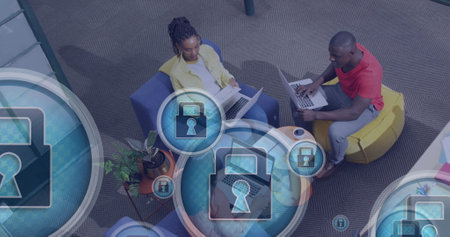 Image of padlock in circles, overhead view of diverse coworkers planning strategy in office. Digital composite, multiple exposure, business, protection, discussion, teamwork, technology concept.の写真素材