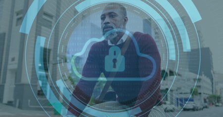 Image of cloud in loading circles, senior thoughtful african american man sitting outdoor. Padlock,...