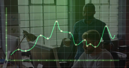 Image of graph and grid pattern over diverse coworkers discussing on desk in office. Digital...
