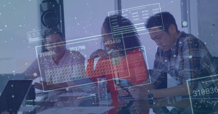 Image of screens with numbers and graphs over diverse colleagues discussing in office. Digital composite, business, report, data, tablet, planning, ideas, teamwork and technology.の写真素材