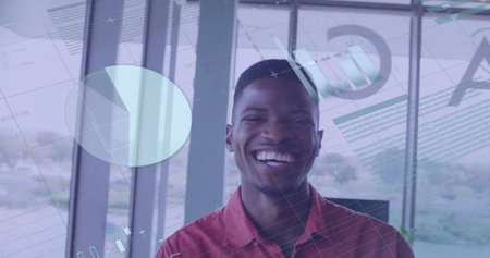 Image of financial data processing over smiling african american businessman in office. Global finance, business, connections, computing and data processing concept digitally generated image.の写真素材