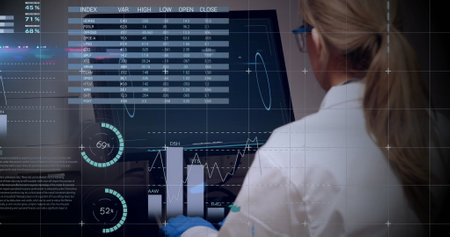 Image of scientific data processing over caucasian female scientist with computer in laboratory. Global science, research, computing and data processing concept digitally generated image.の写真素材