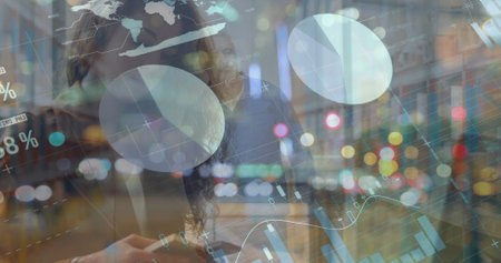 Image of statistical data processing over caucasian woman using laptop and smartphone at office. Business data technology conceptの写真素材