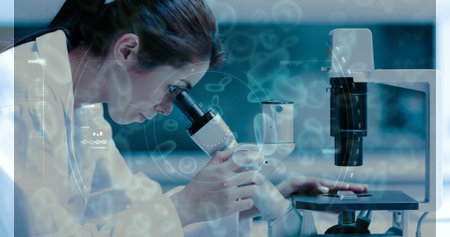 Image of female scientist looking into a microscope combined with animated microorganisms. science...