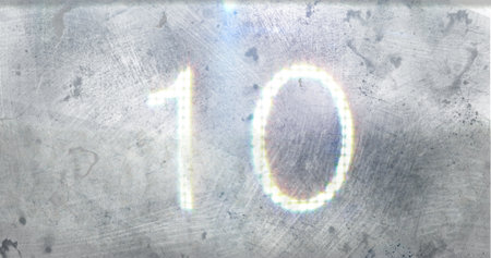 Number ten glowing brightly against textured, metallic background. Light reflections and subtle...