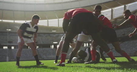 Image of glowing lights over diverse rugby players in sports stadium. rugby, teamwork, sports and competition concept digitally generated image.の写真素材