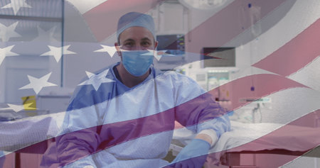 Image of american flag over caucasian male doctor with face mask. patriotism and celebration concept digitally generated image.の写真素材
