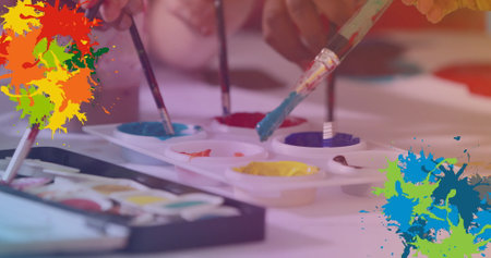 Image of colorful stains over diverse schoolchildren painting. children&#39;s art week, education and digital interface concept digitally generated image.の写真素材