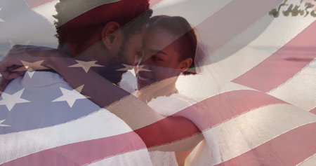 Image of american flag over smiling african american married couple at beach. patriotism and celebration concept digitally generated image.の写真素材