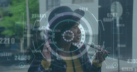 Image of round scanner and changing numbers over asian woman talking on smartphone on the street. Computer interface and business technology conceptの写真素材