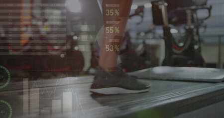 Image of statistical data processing over low section of woman running on treadmill at the gym....