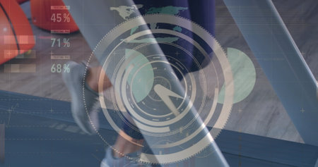 Image of circles and over biracial man using laptop. Global business digital interface technology and networking concept digitally generated image.の写真素材