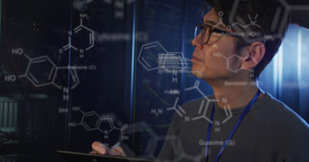 Image of chemical structures and data processing over asian male engineer working at server room. Research science and business data storage technology conceptの写真素材