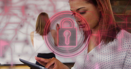 Image of padlock in circles and navigation pattern over biracial woman using tablet. Digital composite, multiple exposure, direction, shape, protection, security and technology concept.の写真素材