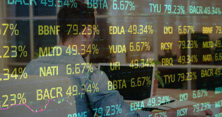 Image of financial data processing over caucasian businessman using laptop at office. Global...