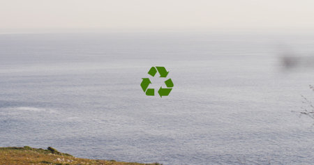 Image of recycling, sustainability and ecology icons over landscape. Ecology, sustainability and data processing concept digitally generated imageの写真素材