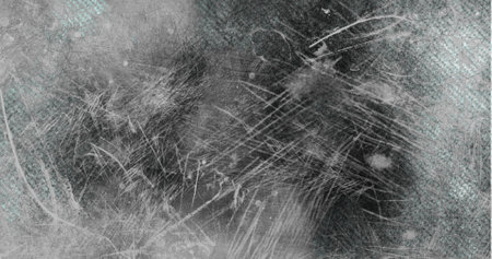 Abstract image showing textured surface with various scratches and marks. The background has a mix of dark and light shades, creating a distressed and worn lookの写真素材
