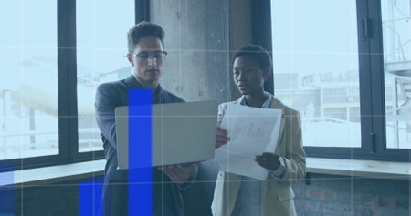 Image of financial data processing over diverse business people using laptop. global business, finance and digital interface concept digitally generated image.の写真素材