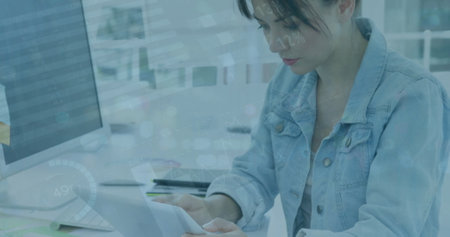 Image of infographic interface over smiling caucasian businesswoman using tablet at desk. Digital...