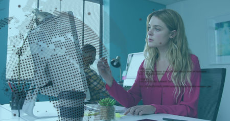 Image of rotating globe and computer language over caucasian woman analyzing reports. Digital composite, multiple exposure, globalization, coding, programming language and technology concept.の写真素材