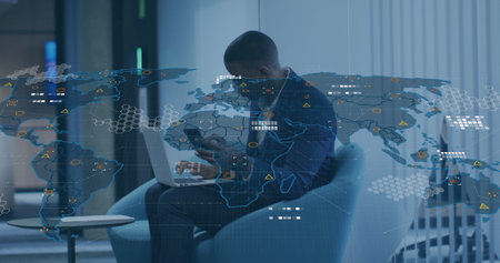 Image of world map over african american businessman with laptop using smartphone at office. Global...