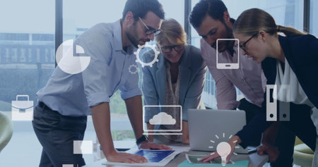 Image of digital icons over diverse colleagues discussing together at office. Global networking and business technology conceptの写真素材