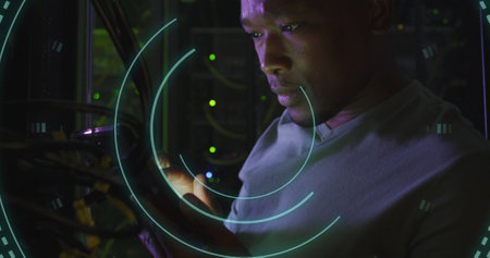 Image of scope scanning over african american male hacker in server room. Global business, security...