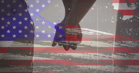 American flag with glitch effect against mid section of couple holding hands at the beach. american...
