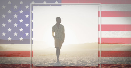 American flag with glitch effect against african american man walking on the beach. american independence patriotic holiday conceptの写真素材