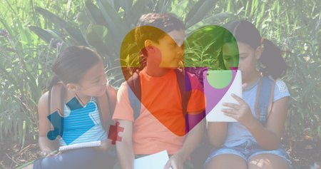 Image of colourful puzzle pieces and heart over kids friends using electronic devices. autism,...
