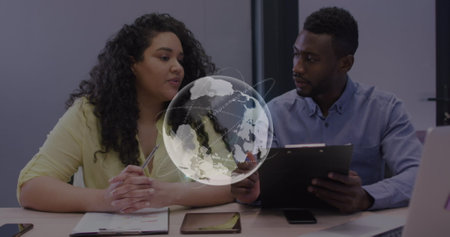 Image of globe and data processing over diverse business colleagues at office. Global communication, data and business network concept digitally generated image.の写真素材